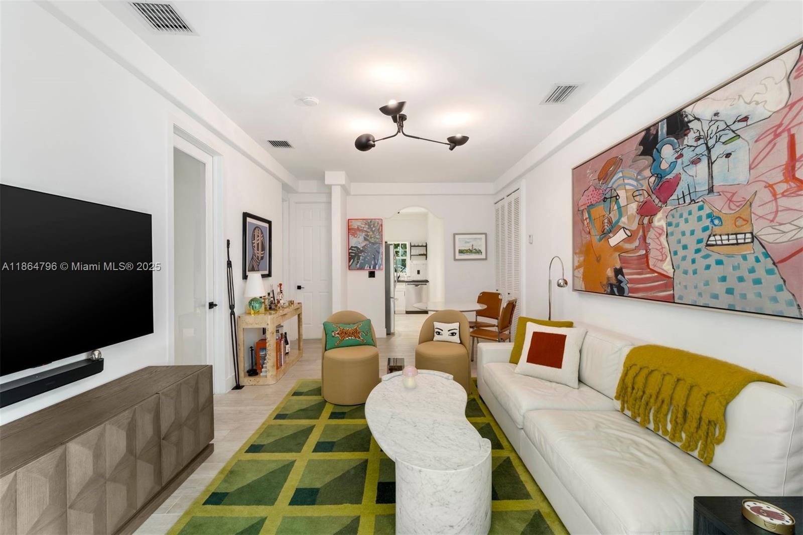 1045 Michigan Avenue, Unit B Miami Beach, FL 33139 - Photo 4 of 15 a living room with furniture and a flat screen tv