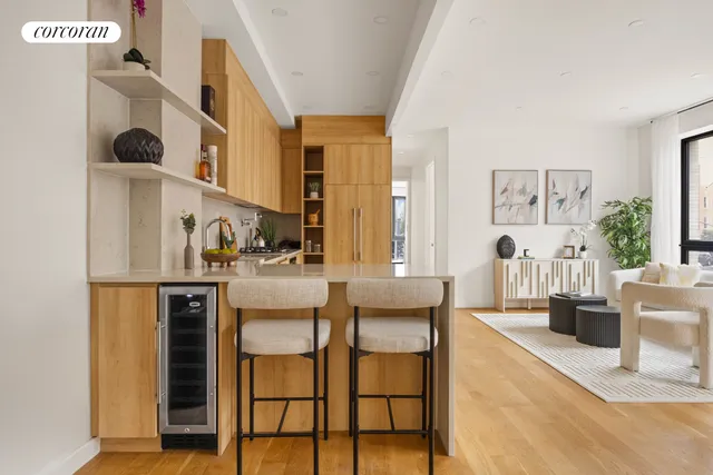 a dining room with furniture and large windows