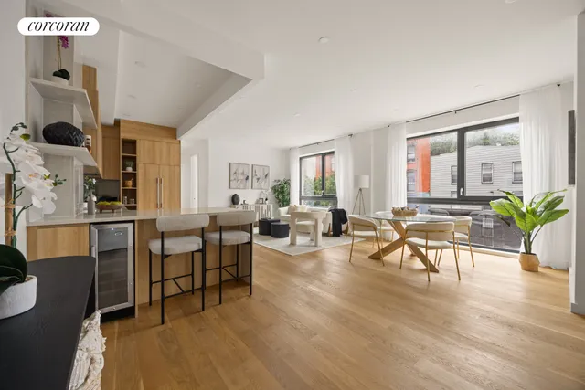 a kitchen with stainless steel appliances granite countertop a sink and a refrigerator