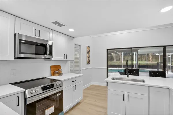 a bedroom with a large bed and a ceiling fan
