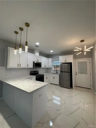 a kitchen with a refrigerator sink and microwave