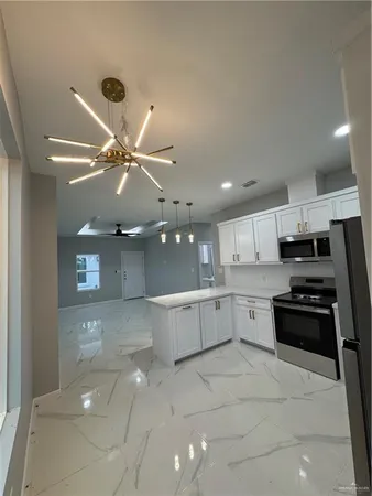 a kitchen with a stove a refrigerator a sink and a stove