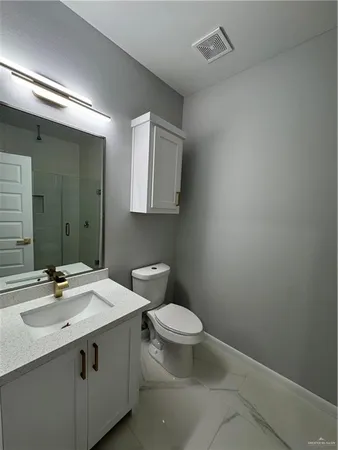a bathroom with a sink toilet and mirror