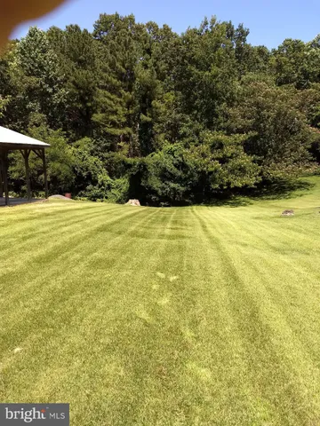 a view of a large yard with an outdoor space