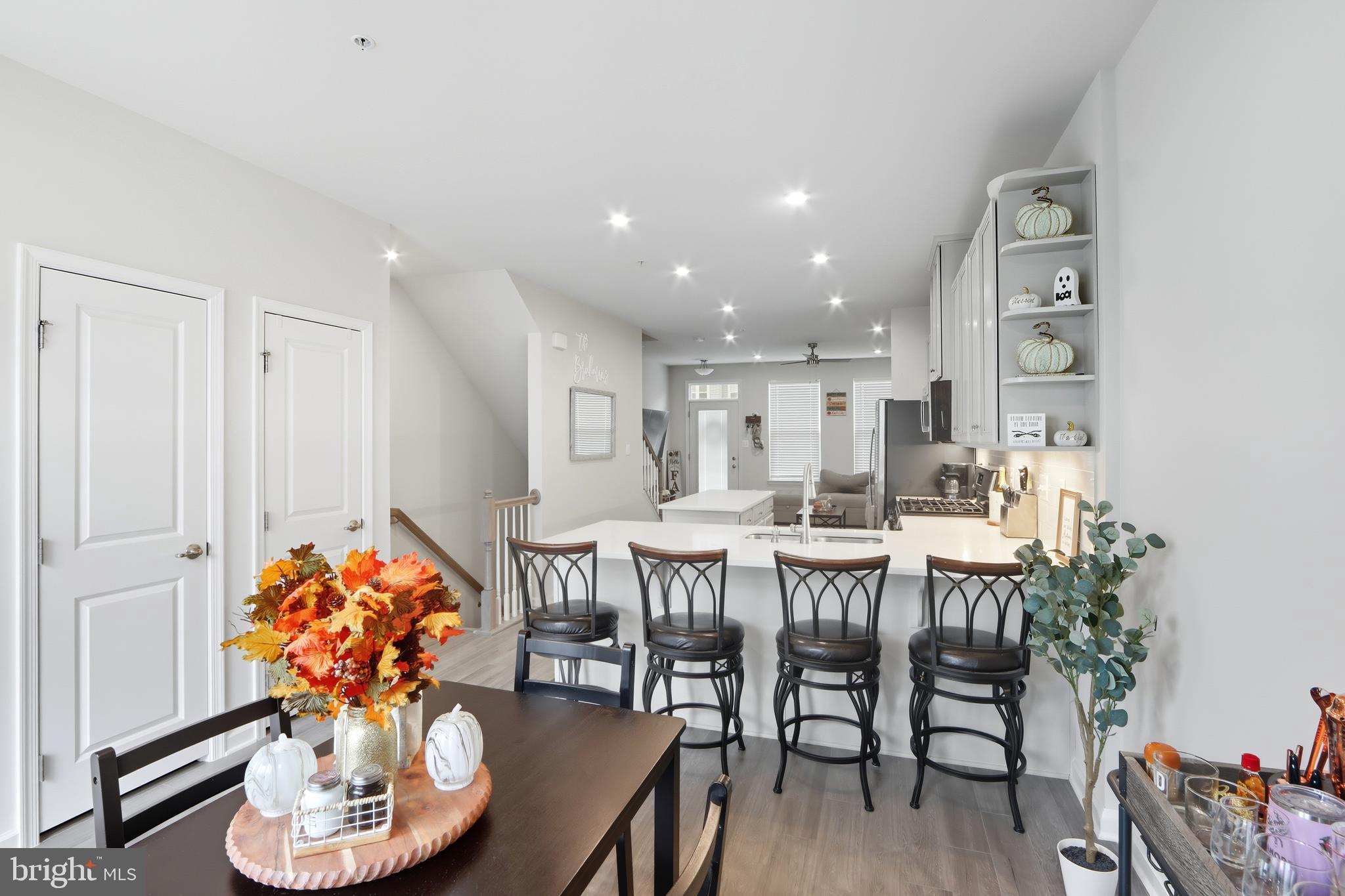 3458 Jacobs Ford Way Hanover, MD 21076 - Photo 13 of 39 a dining room with furniture potted plants and wooden floor