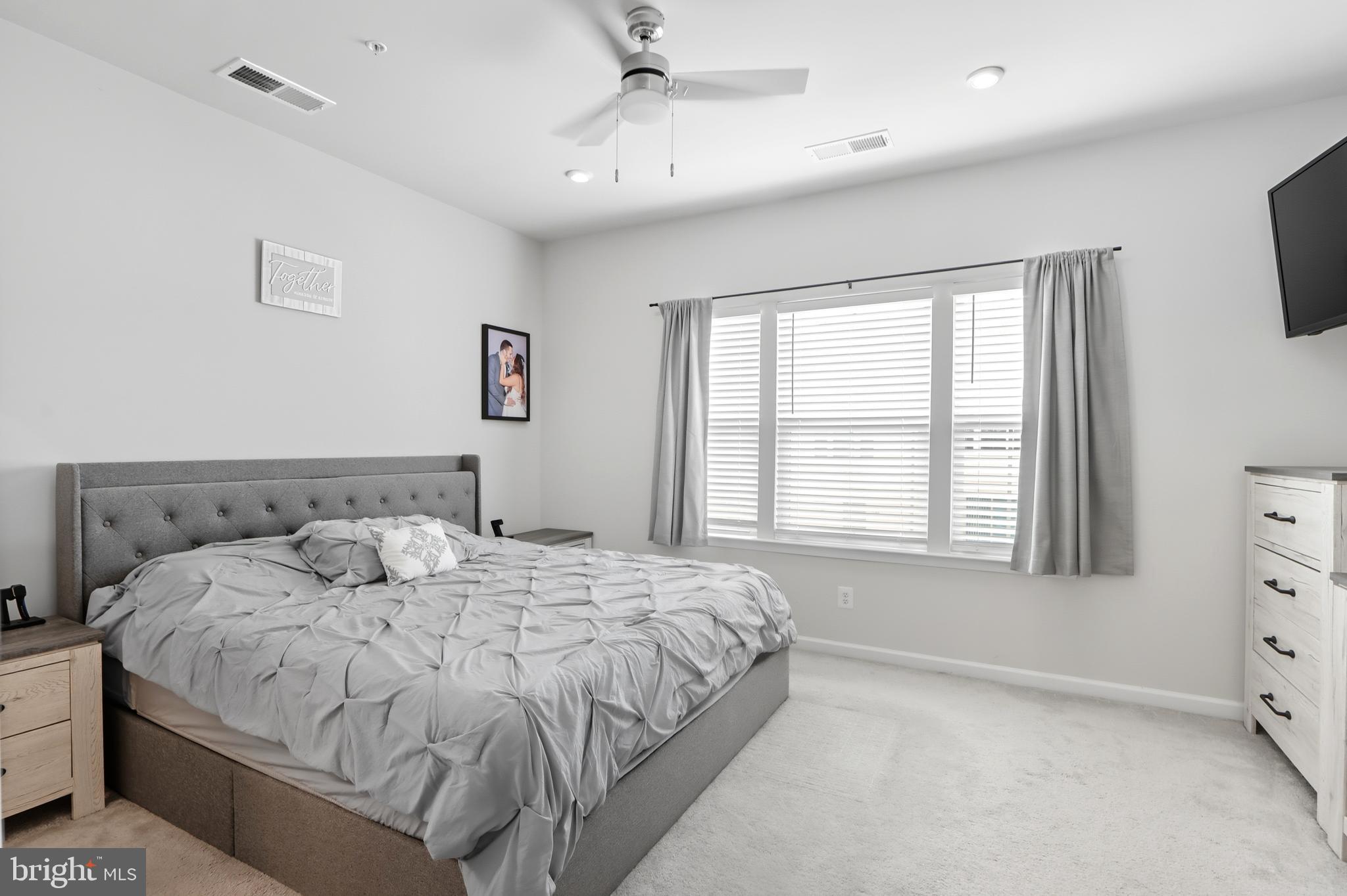 3458 Jacobs Ford Way Hanover, MD 21076 - Photo 19 of 39 a bedroom with a bed and a flat tv screen on dresser