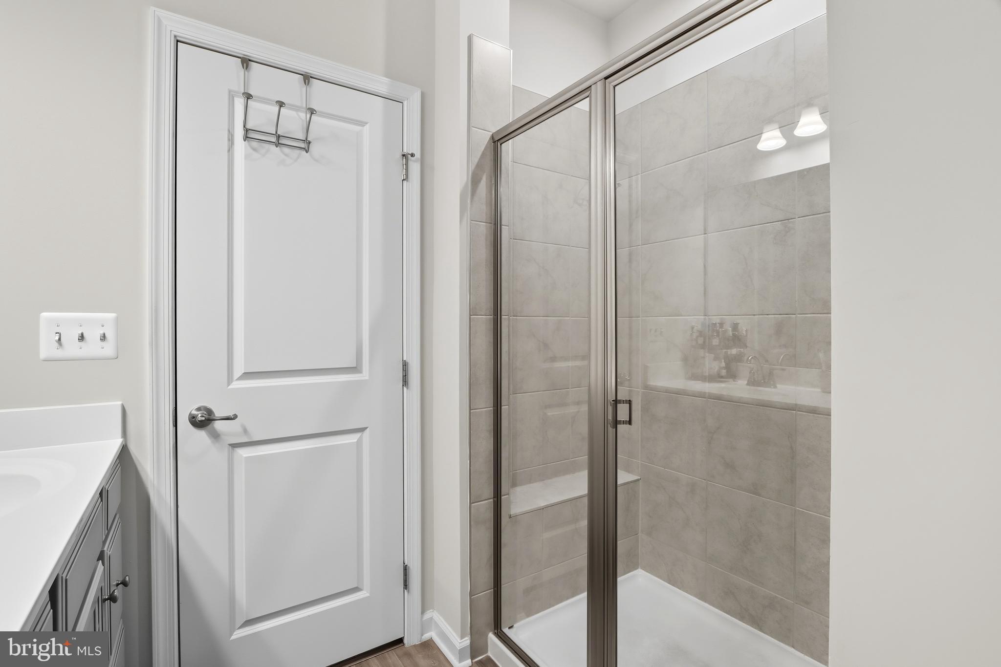 3458 Jacobs Ford Way Hanover, MD 21076 - Photo 23 of 39 a bathroom with a shower and a glass door