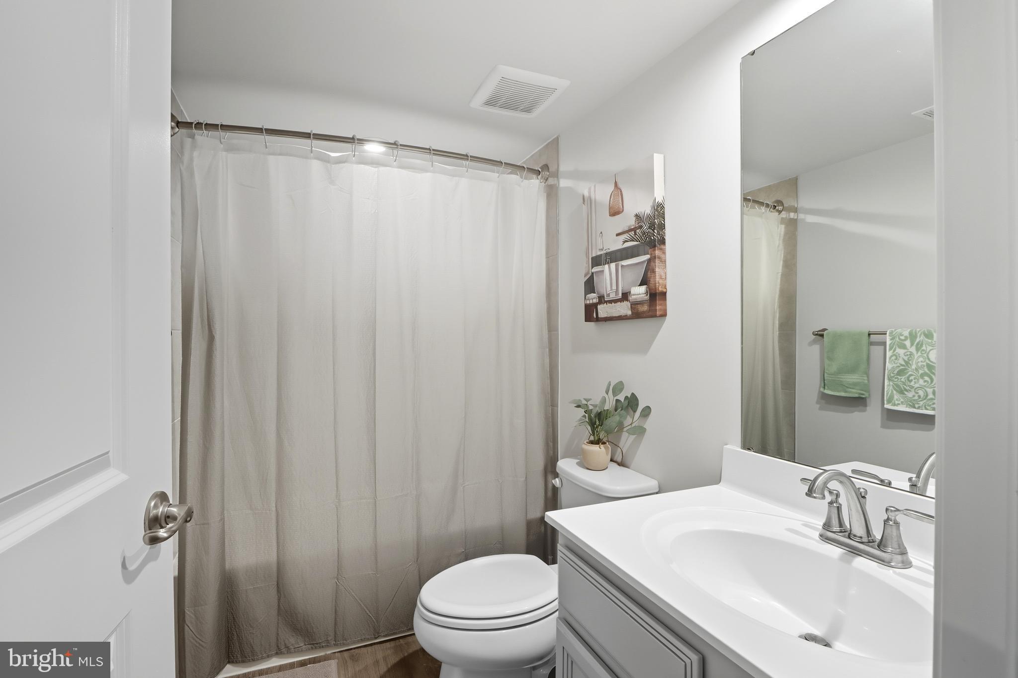 3458 Jacobs Ford Way Hanover, MD 21076 - Photo 28 of 39 a bathroom with a sink a toilet and shower curtain