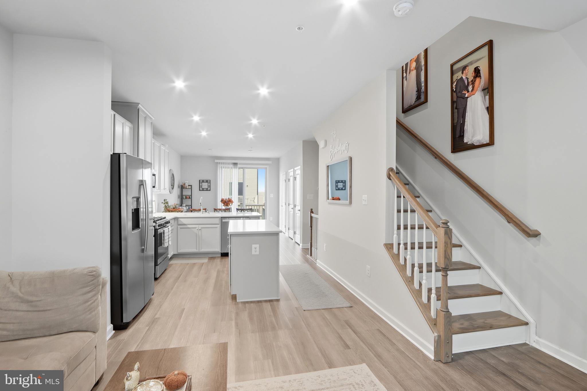 3458 Jacobs Ford Way Hanover, MD 21076 - Photo 6 of 39 a view of a living room filled with furniture hardwood floor and a kitchen view