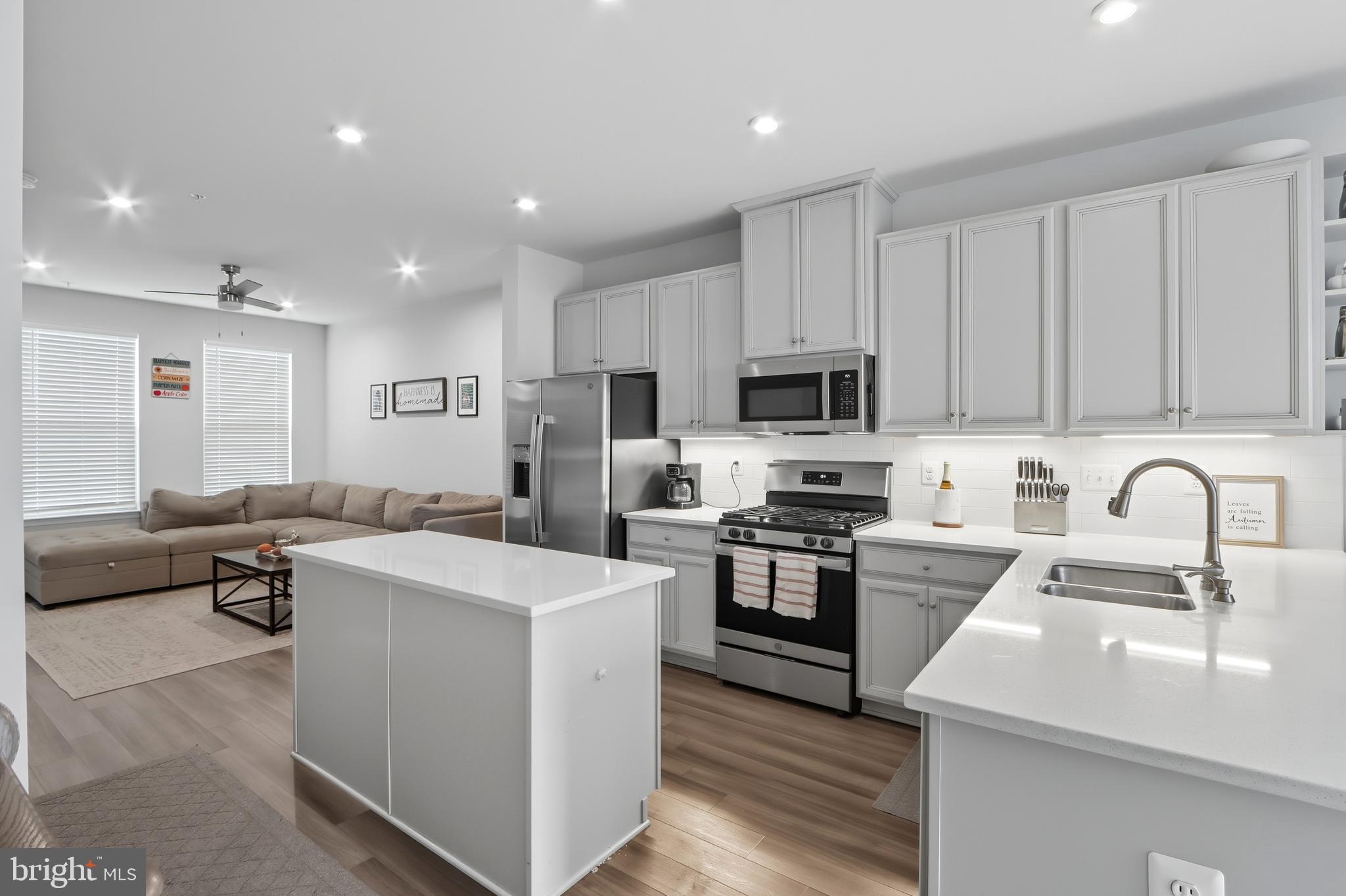 3458 Jacobs Ford Way Hanover, MD 21076 - Photo 10 of 39 a kitchen with kitchen island a sink stainless steel appliances and cabinets