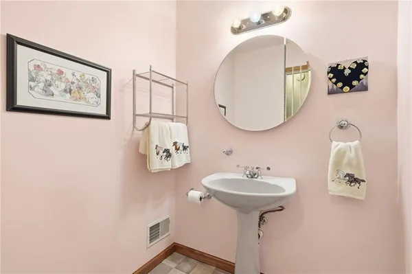 a bedroom with a bed a mirror and dresser with wooden floor