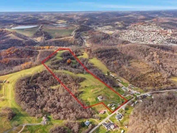 a view of a kitchen with fridge and wooden floor