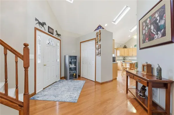 a very nice looking kitchen with granite countertop a large window cabinets and stainless steel appliances
