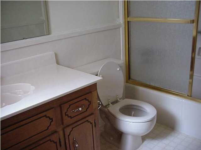 640 Ridge Lake Road Crestview, FL 32536 - Photo 10 of 10 a bathroom with a toilet a sink and wooden floor