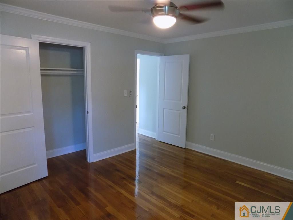 152 Orange Street Edison, NJ 08817 - Photo 11 of 23 an empty room with wooden floor closet and windows