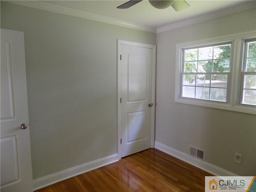 152 Orange Street Edison, NJ 08817 - Photo 13 of 23 an empty room with wooden floor and windows