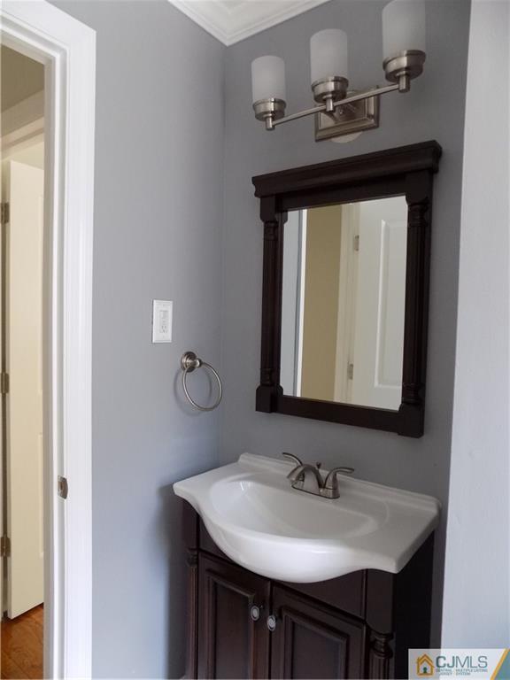 152 Orange Street Edison, NJ 08817 - Photo 15 of 23 a bathroom with a sink and a mirror