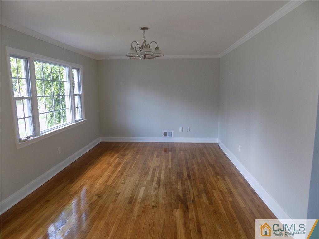 152 Orange Street Edison, NJ 08817 - Photo 7 of 23 wooden floor in an empty room with a window