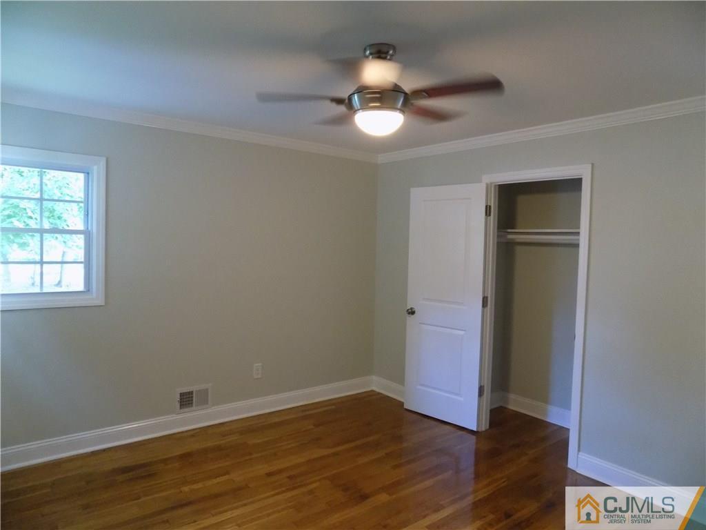 152 Orange Street Edison, NJ 08817 - Photo 9 of 23 a view of an empty room with wooden floor and a window