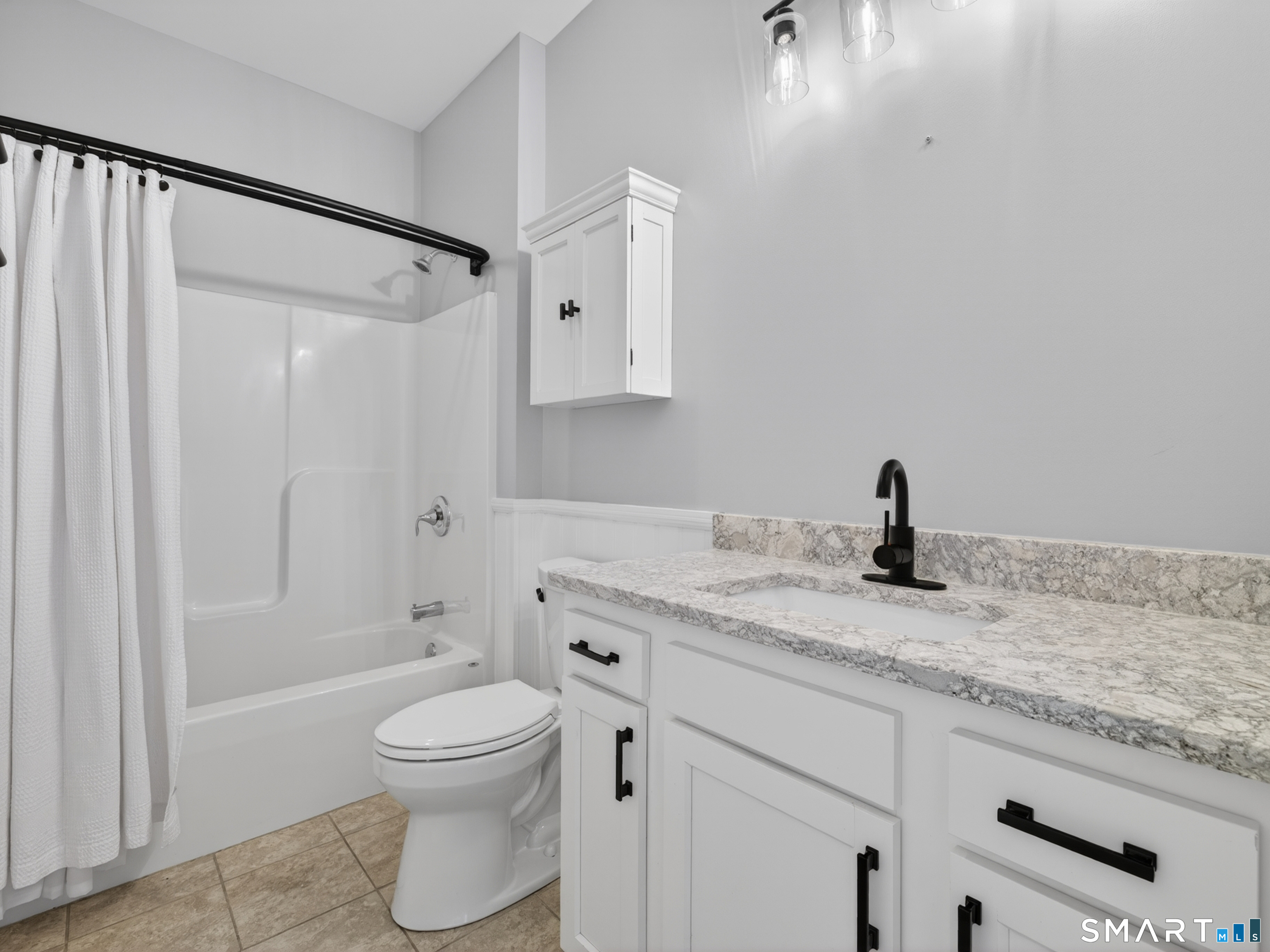 650 Ridgewood Road Middletown, CT 06457 - Photo 29 of 40 a bathroom with a granite countertop sink toilet a mirror and shower
