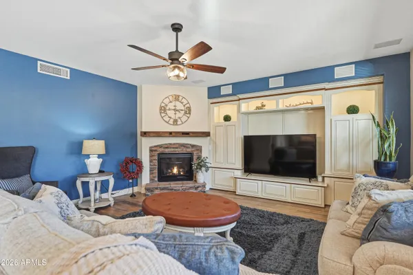 a living room with furniture and a wooden floor
