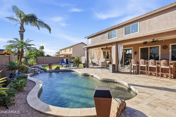 a view of a swimming pool with outdoor seating