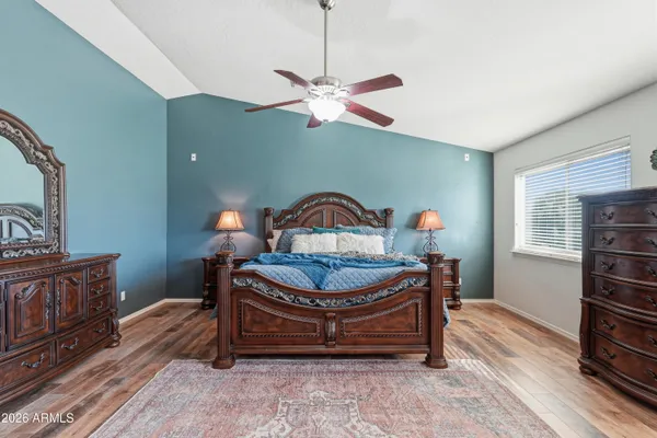 a bedroom with two beds and a large window
