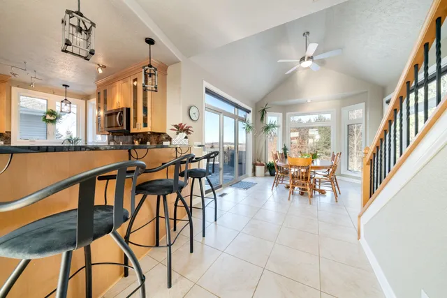 a view of a dining room with furniture a chandelier and wooden floor