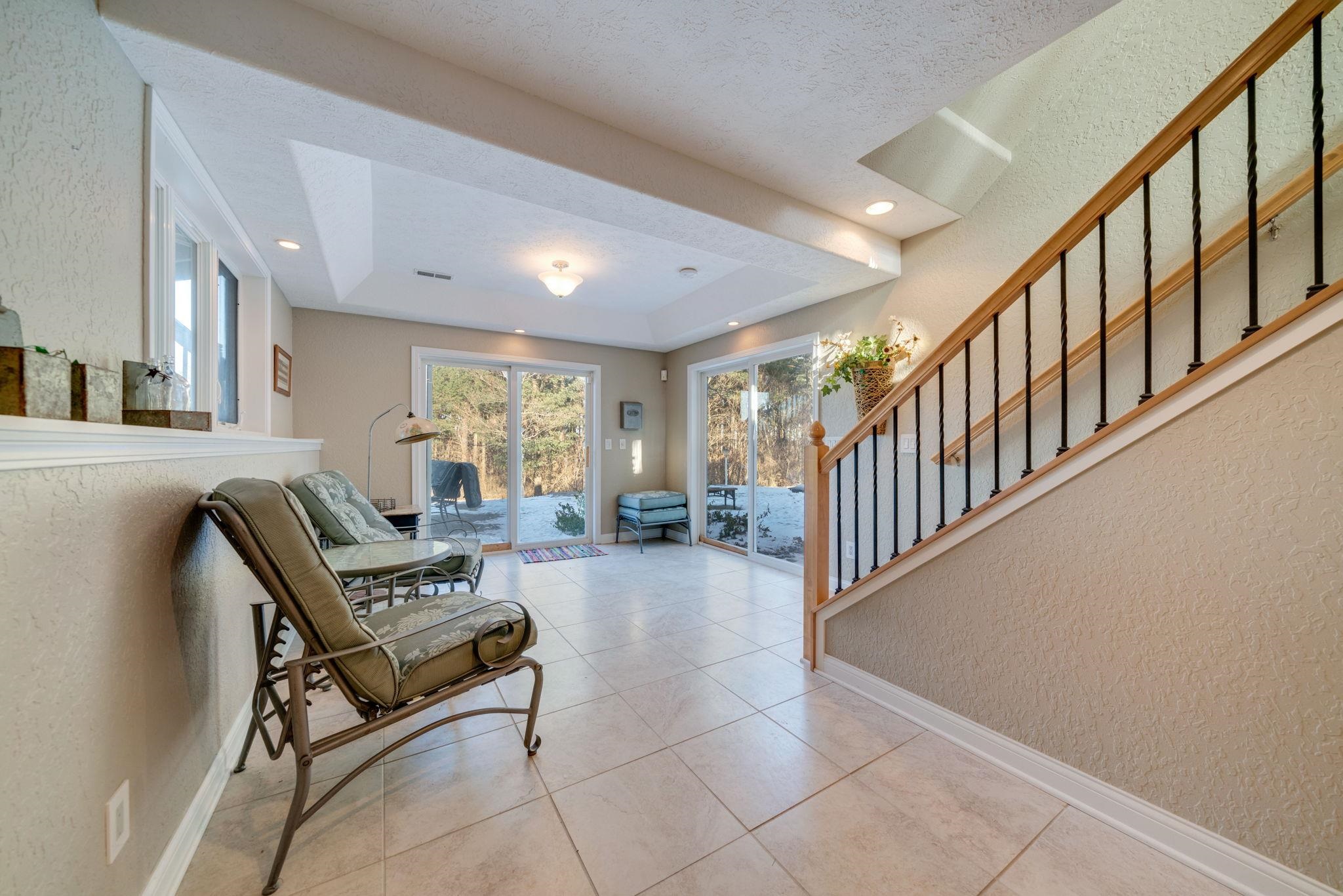 4092 West Pond Road Leaf River, IL 61047 - Photo 27 of 71 a living room with couches and a dining table with wooden floor