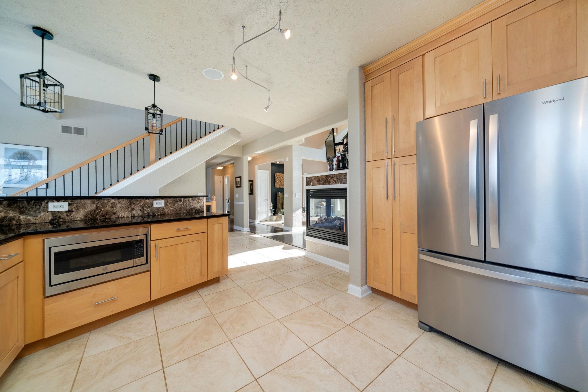 4092 West Pond Road Leaf River, IL 61047 - Photo 4 of 71 a kitchen with stainless steel appliances a refrigerator and a stove top oven