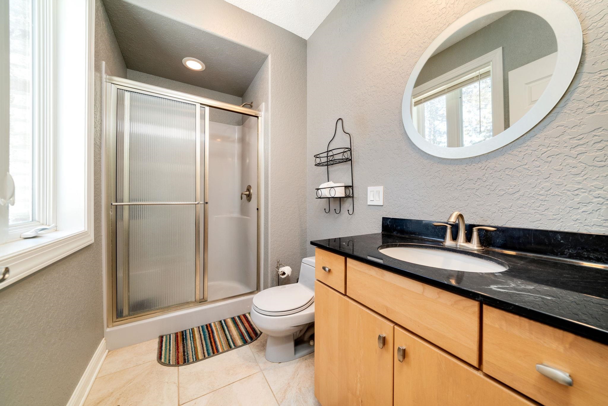 4092 West Pond Road Leaf River, IL 61047 - Photo 44 of 71 a bathroom with a granite countertop sink a toilet and a mirror
