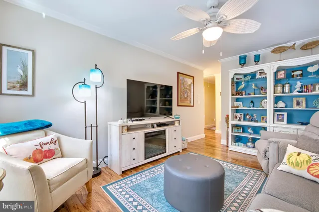 a living room with furniture and a book shelf