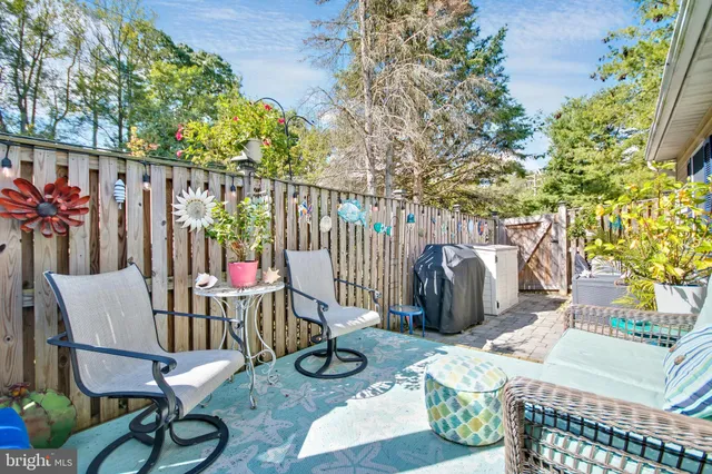 a outdoor living space with furniture potted plant and a large window