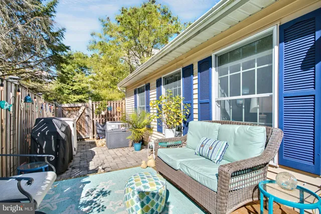 a view of a patio with table and chairs and potted plants