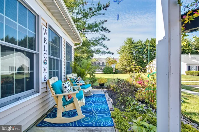 a front view of house with a garden and patio
