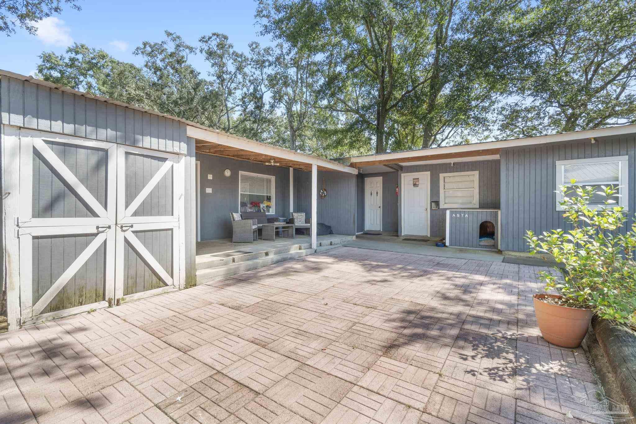 1911 Mathison Road Cantonment, FL 32533 - Photo 13 of 66 a view of a house with backyard and sitting area