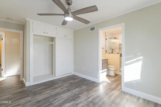 a bathroom with a toilet a sink and glass shower