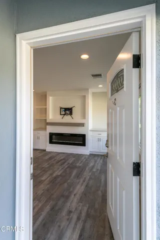 a view of a hallway with wooden floor