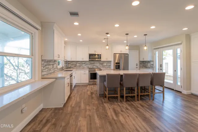 a large kitchen with a table and chairs