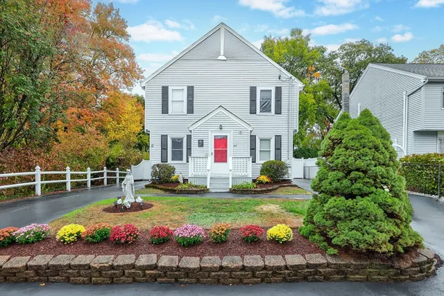 a view of a house with yard and sitting area