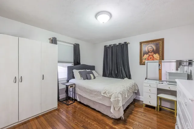 a bedroom with a bed and a desk