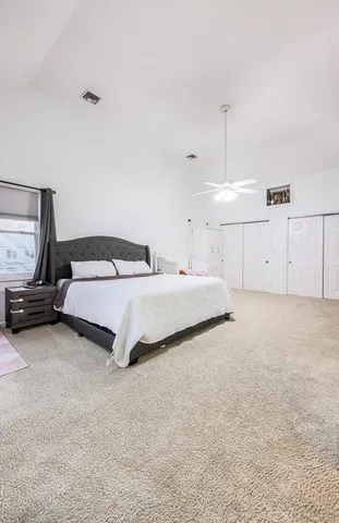 a bedroom with a bed and ceiling fan