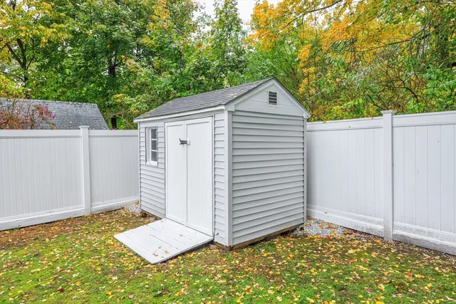 a view of house with backyard and trees