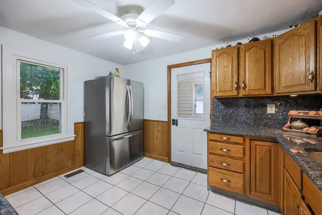 a kitchen with stainless steel appliances granite countertop a refrigerator a stove a sink and dishwasher
