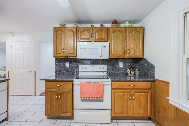 a kitchen with stainless steel appliances granite countertop a stove and a microwave