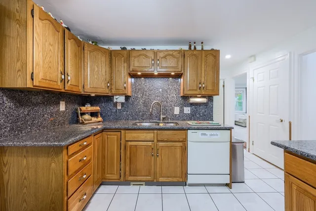 a kitchen with granite countertop a sink and cabinets