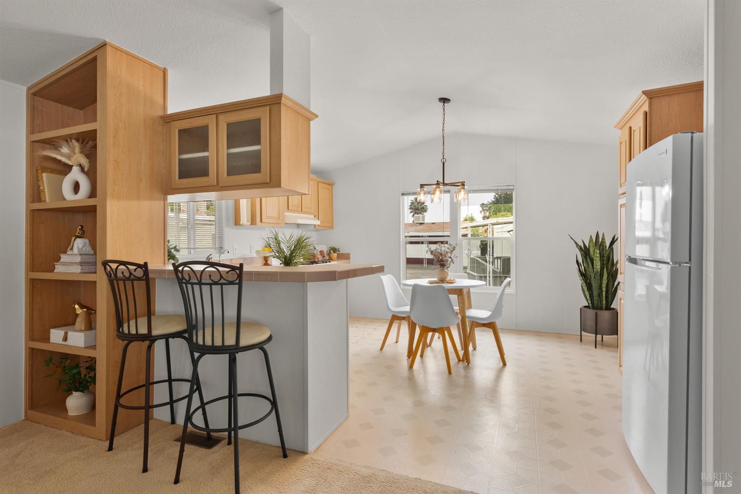 5754 Lois Avenue Santa Rosa, CA 95403 - Photo 8 of 23 a dining room with furniture potted plants and wooden floor