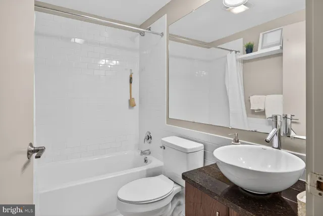 a bathroom with a sink toilet a mirror and shower