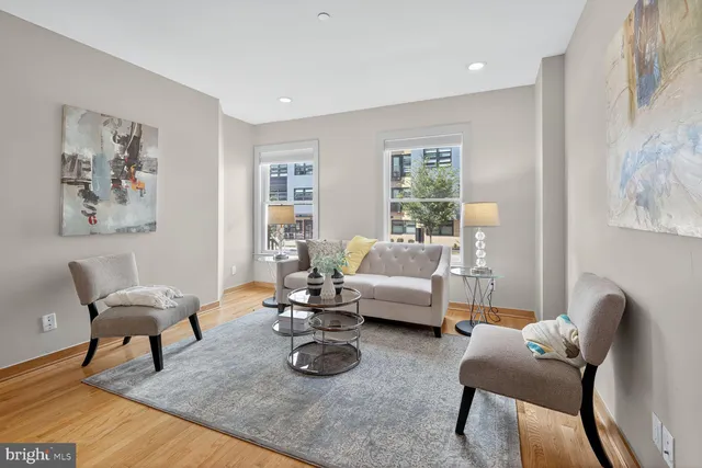 a living room with furniture rug and window