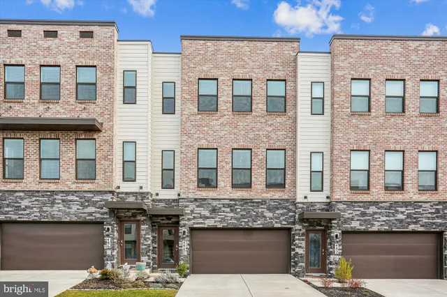 a front view of a brick building with a lot of windows